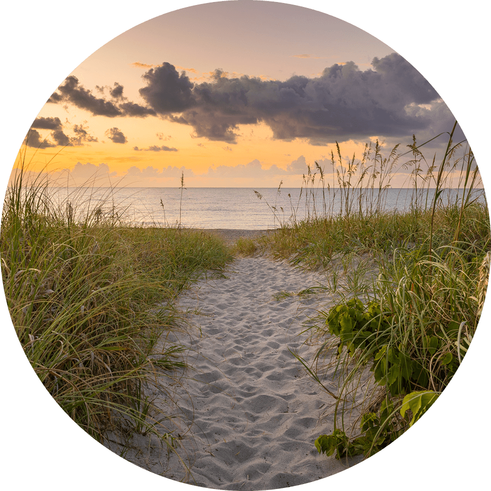 Sunset beach path leading to the ocean.