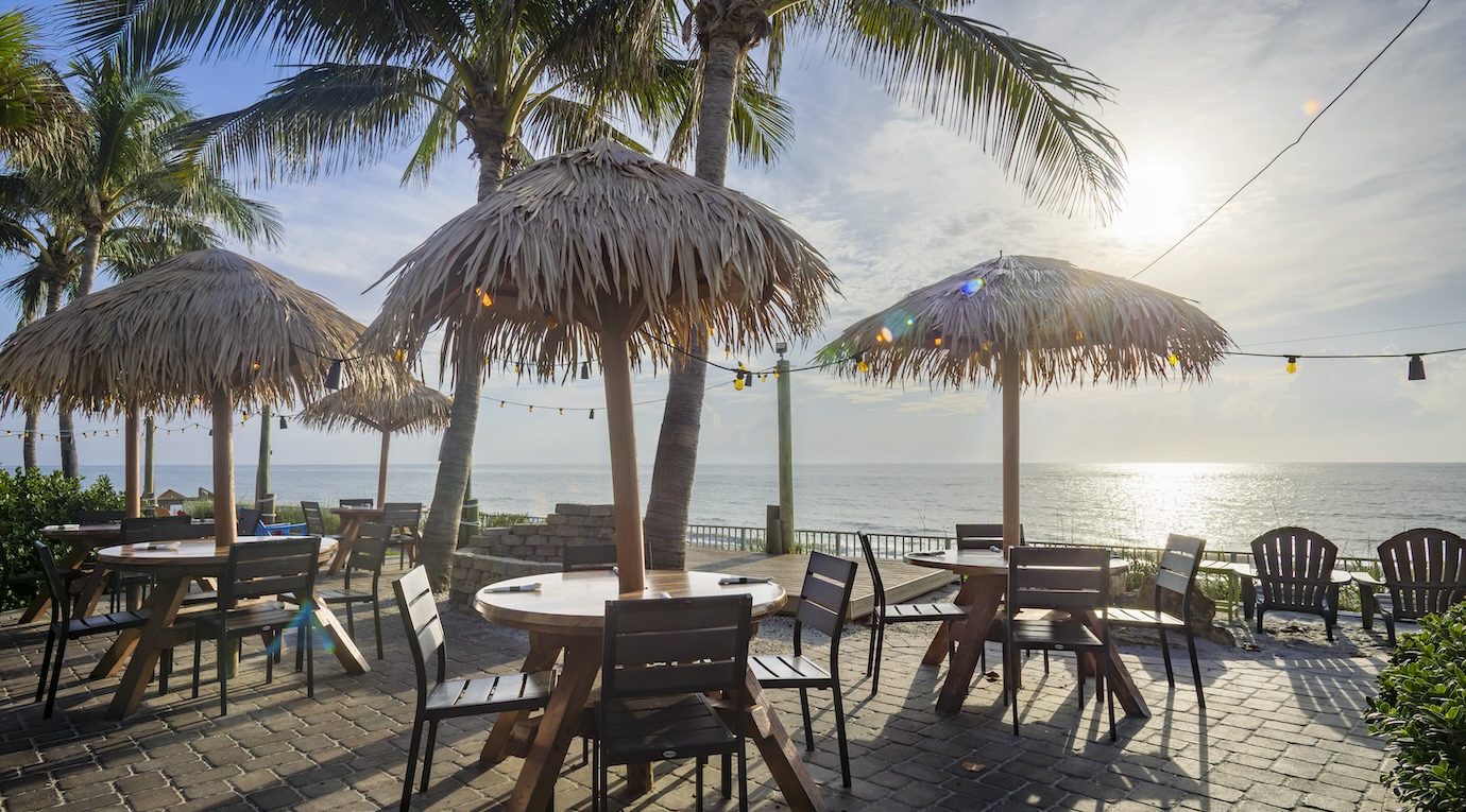 Mulligans Beachfront Patio with palm trees