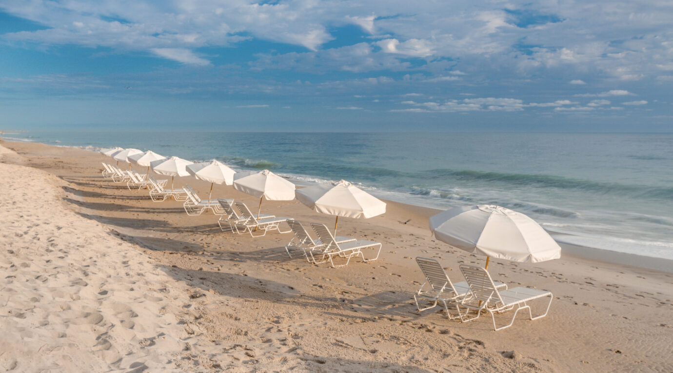 row of beach chairs on the beach