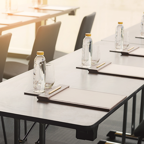 conference tables with water bottles and notes pads