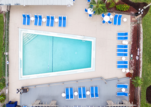 An aerial view of a swimming pool and lounge chairs.