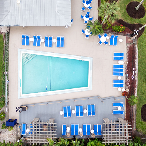 An aerial view of a swimming pool and lounge chairs.