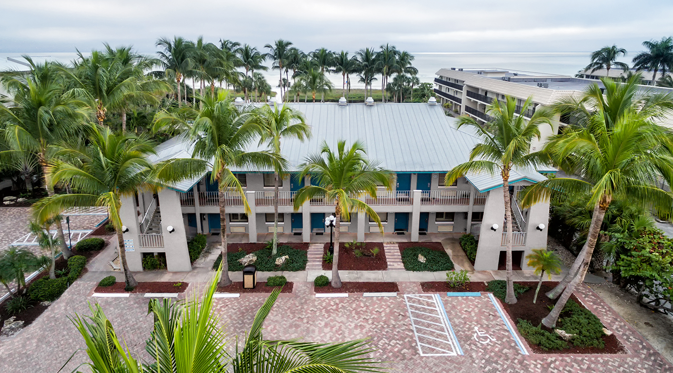 An aerial view of an apartment complex with palm trees.