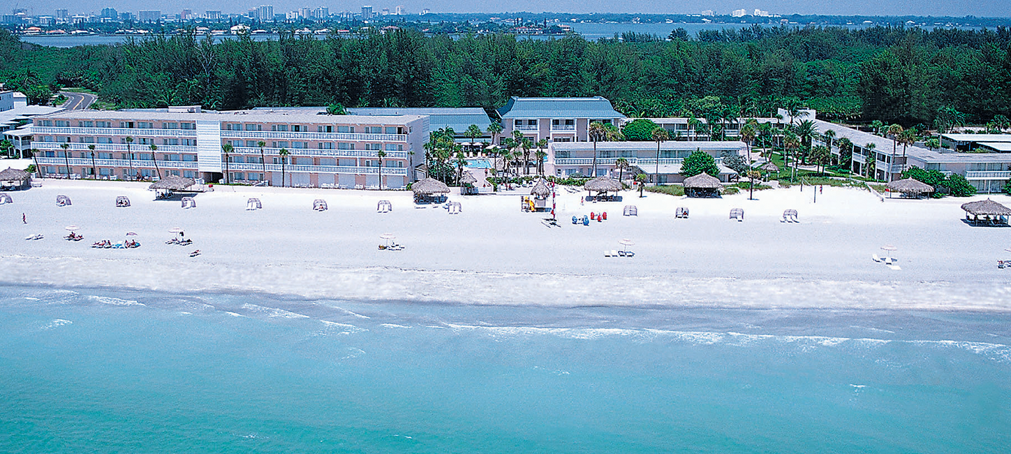 An aerial view of a hotel on the beach.