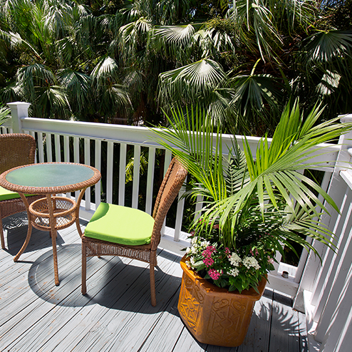 A wooden deck with a table and chairs.