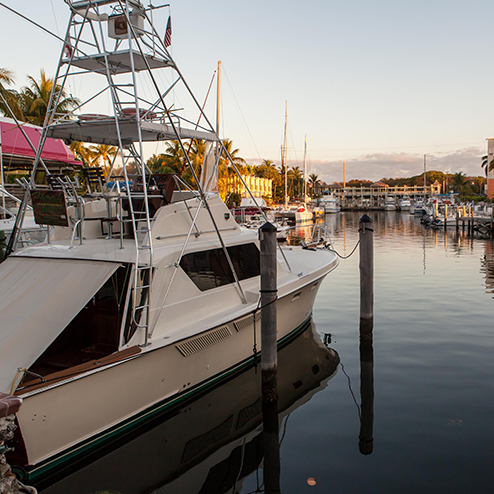 A white boat docked at a dock.