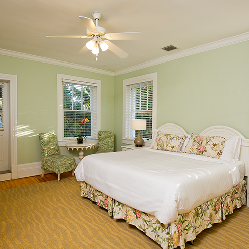 A bed in a room with green walls.