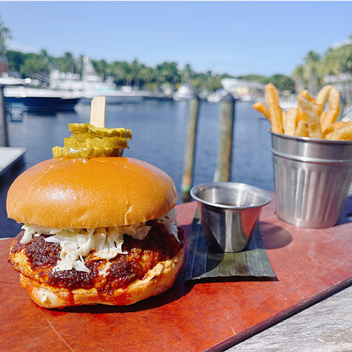 A burger on a wooden board.