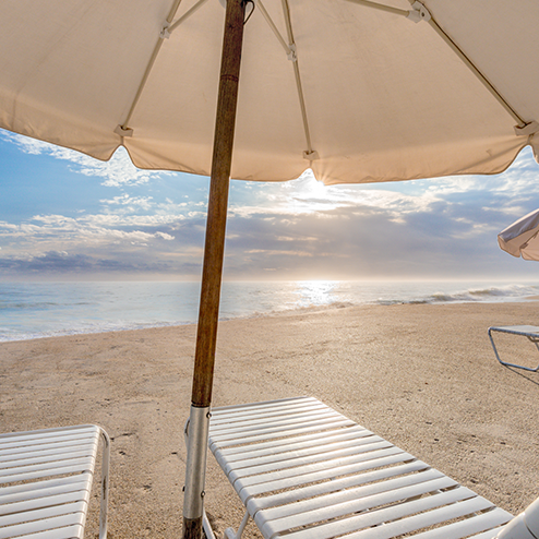 A white umbrella on the beach.