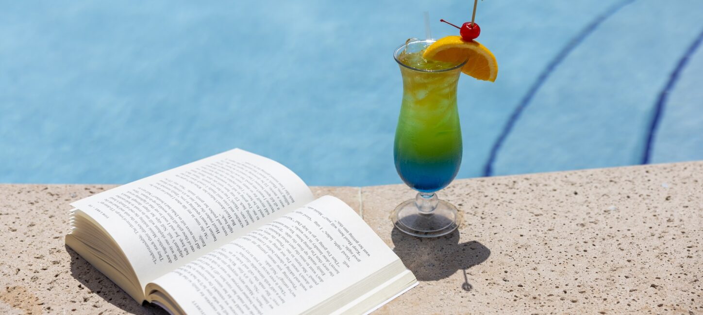 OBI Vero Poolside colorful cocktail and book